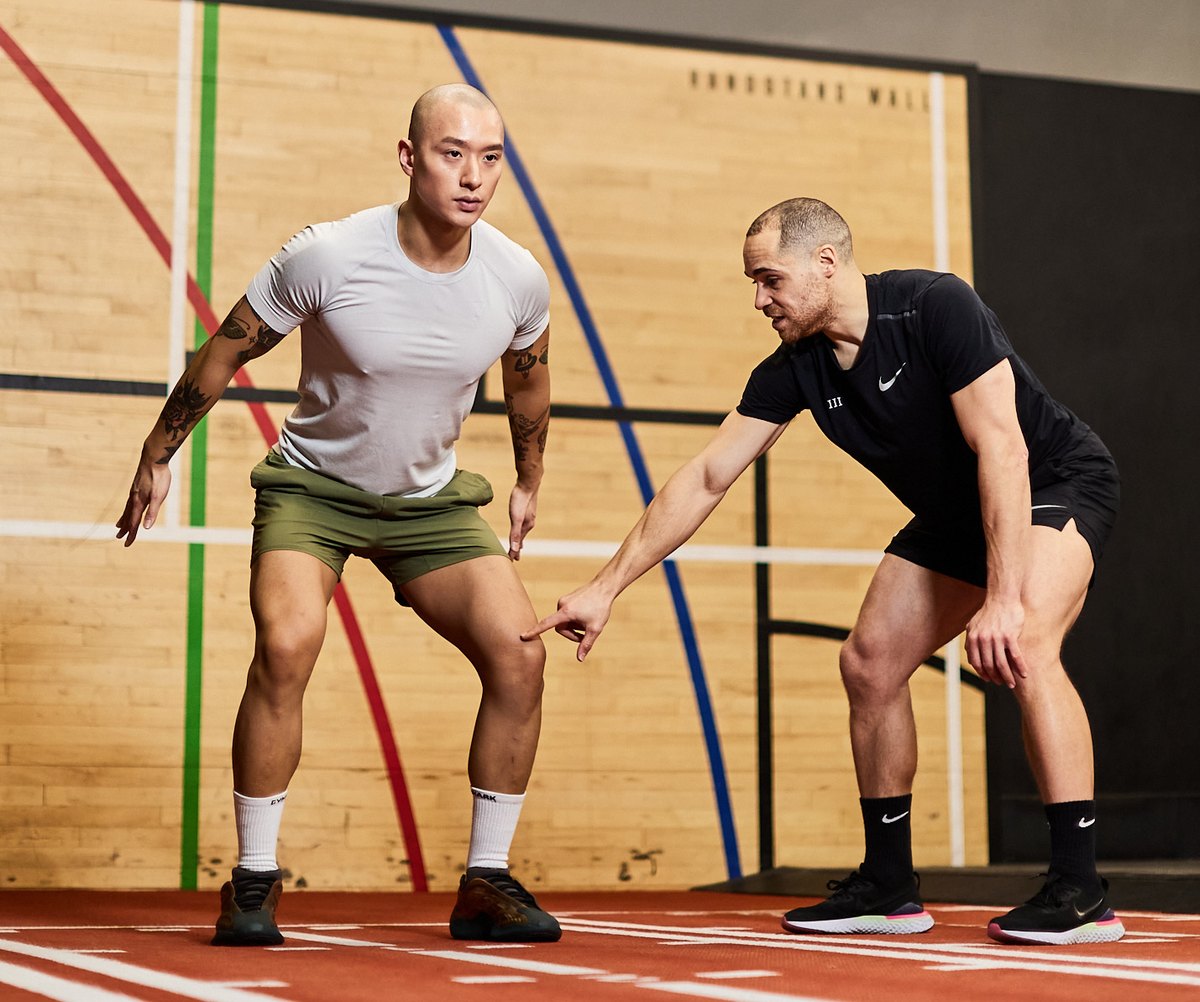 Loui coaching an athlete's knee position during a movement drill