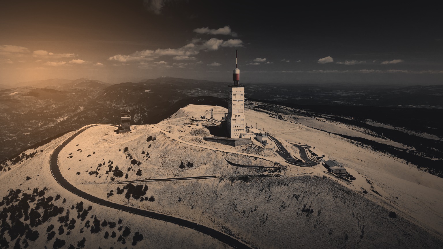 The summit of Mont Ventoux at dusk, the road curving up to the observatory tower